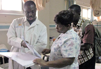 Oteng Rockefeller with medical workers